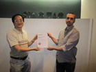 The plant manager and project manager display the certificate.